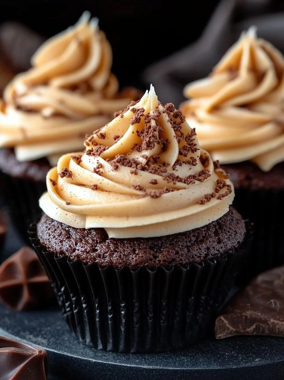 Chocolate Pumpkin Cupcakes with Creamy Pumpkin Frosting 2 Chocolate pumpkin cupcakes with creamy pumpkin frosting on a plate