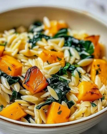 Creamy orzo with roasted butternut squash and spinach in a bowl