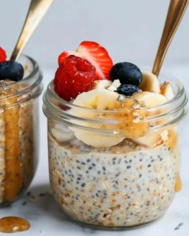 Bowl of customizable high-protein overnight oats with fruits and nuts