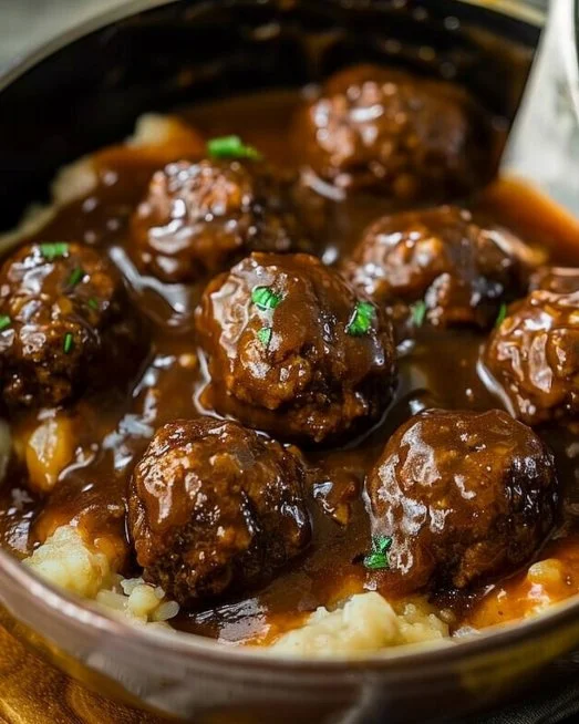 Slow Cooker Salisbury Steak Meatballs served with rich gravy and vegetables