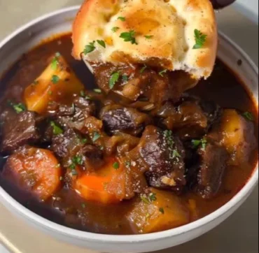 Delicious stove top beef stew simmering with vegetables and spices